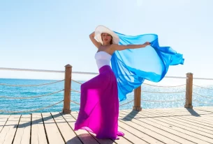 Mulher dançando livremente em meio à natureza, envolta em tecidos fluidos e esvoaçantes, transmitindo leveza, conexão e energia etérea. mulher magnética